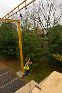 man safely using pulley while attached to anchor track